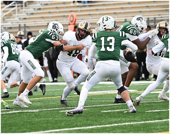A group of football players wearing black and white uniforms. Description generated by AI
