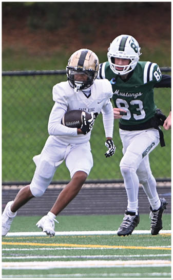 A football player running on the field. Description generated by AI