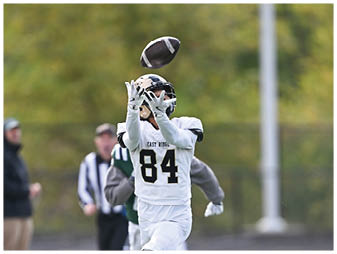 A football player running on the field. Description generated by AI