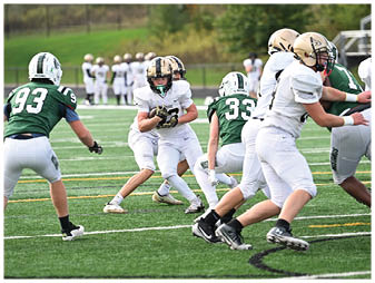 A football player running on the field. Description generated by AI
