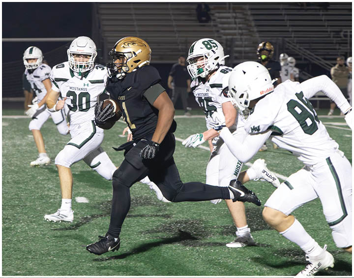 A group of football players wearing black and white uniforms. Description generated by AI