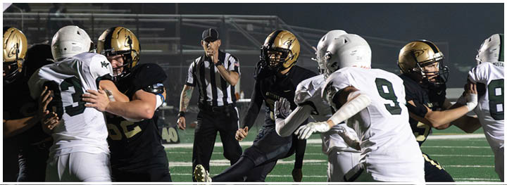 A football player is sliding on the ground. Description generated by AI