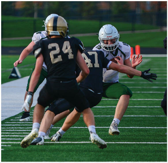 A group of football players wearing black and white uniforms. Description generated by AI