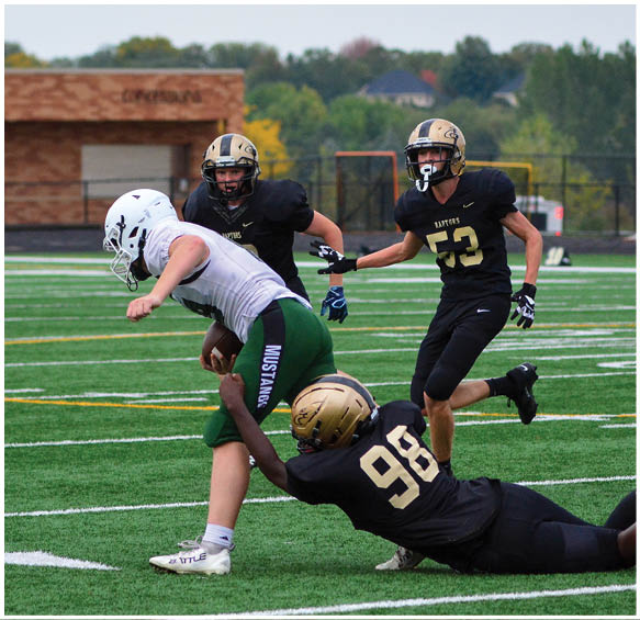 A group of football players wearing black and white uniforms. Description generated by AI