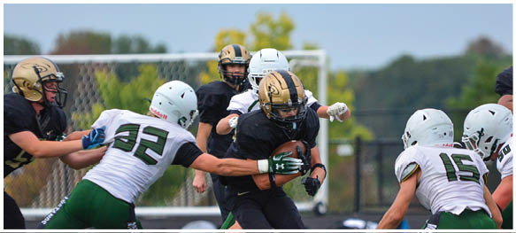 A football player is sliding on the ground. Description generated by AI
