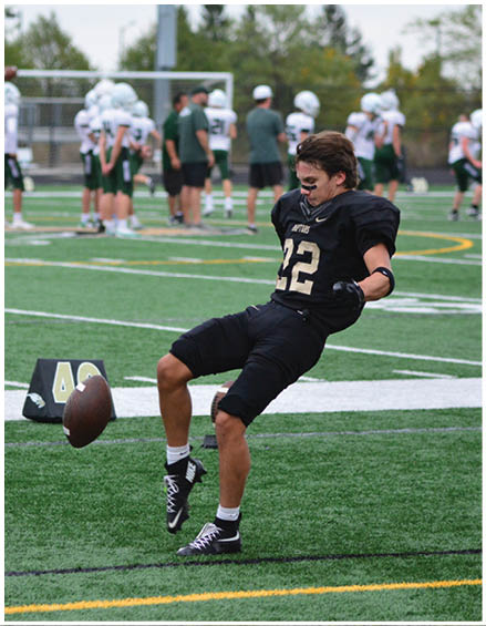 A football player running on the field. Description generated by AI