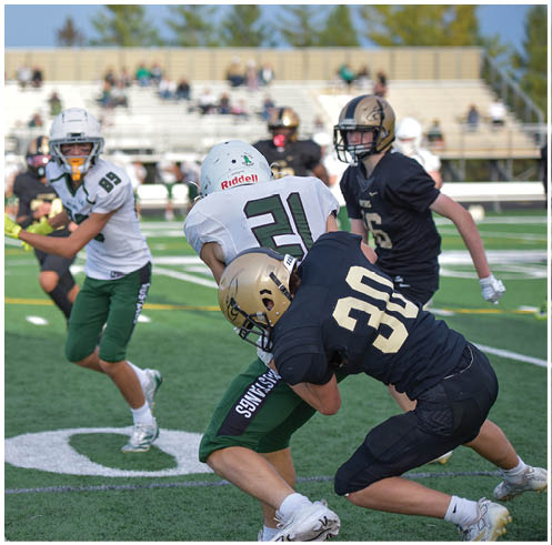 A group of football players wearing black and white uniforms. Description generated by AI