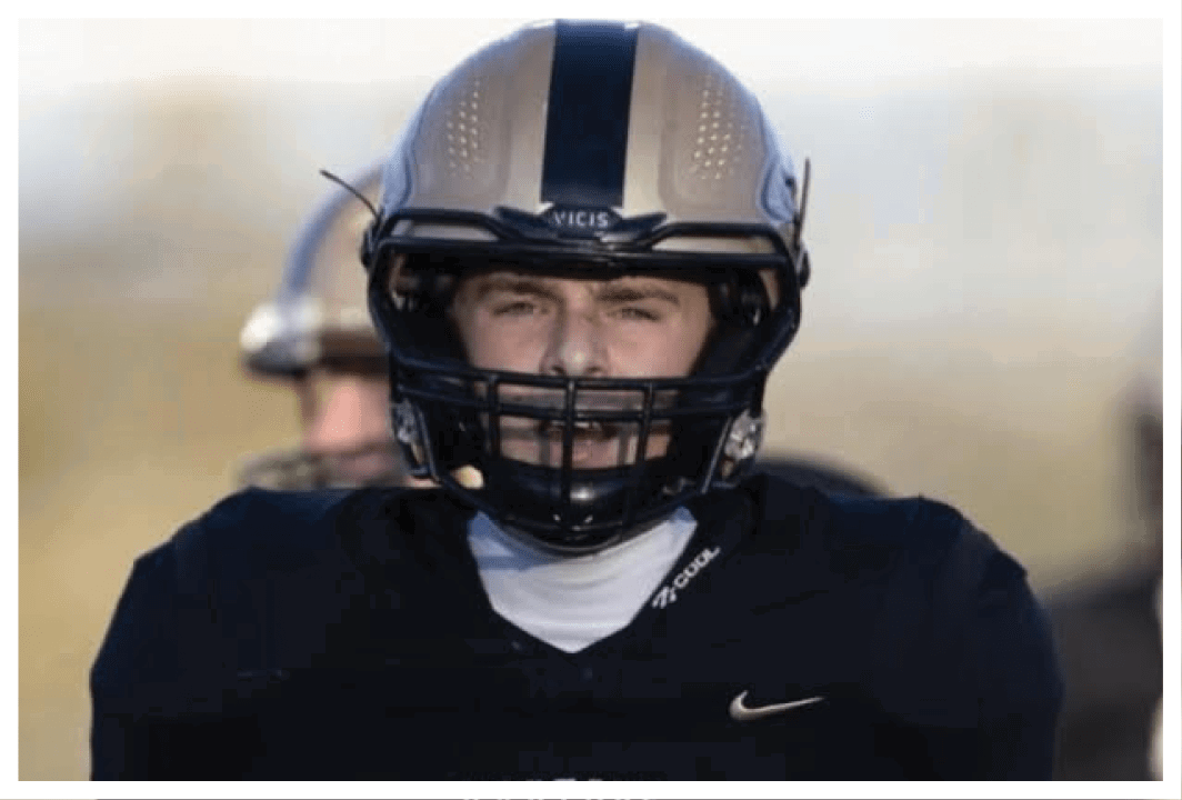 A football player wearing a blue and red jersey. Description generated by AI