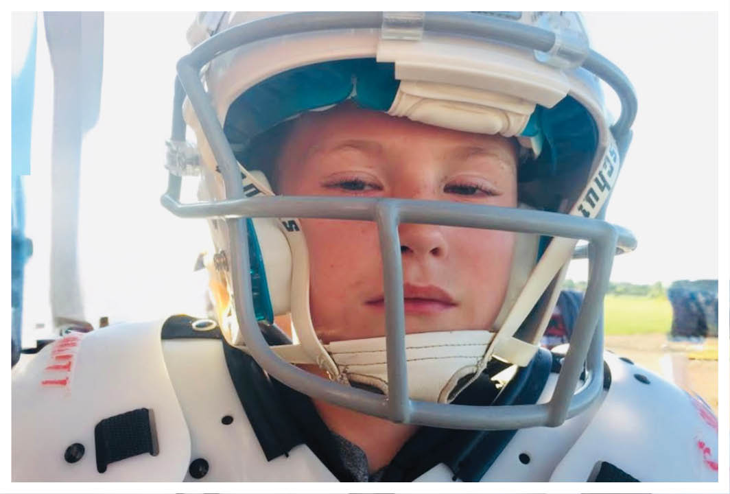 A football player wearing a blue and red jersey. Description generated by AI