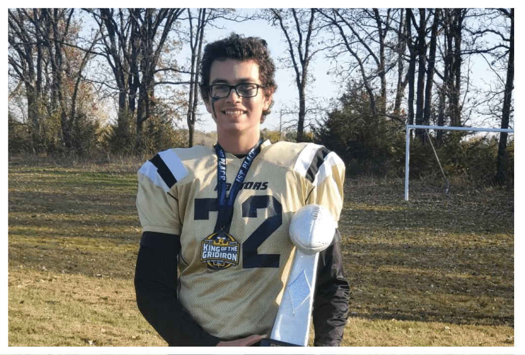 A football player wearing a blue and red jersey. Description generated by AI