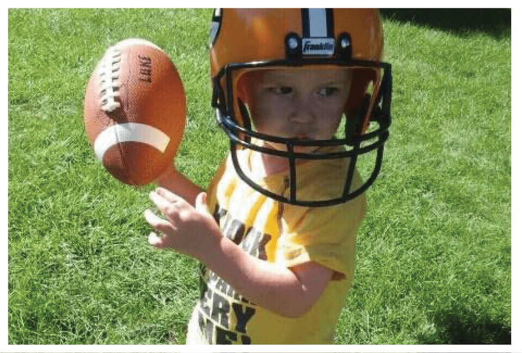 A football player wearing a blue and red jersey. Description generated by AI
