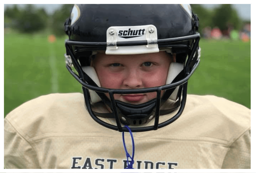 A football player wearing a blue and red jersey. Description generated by AI