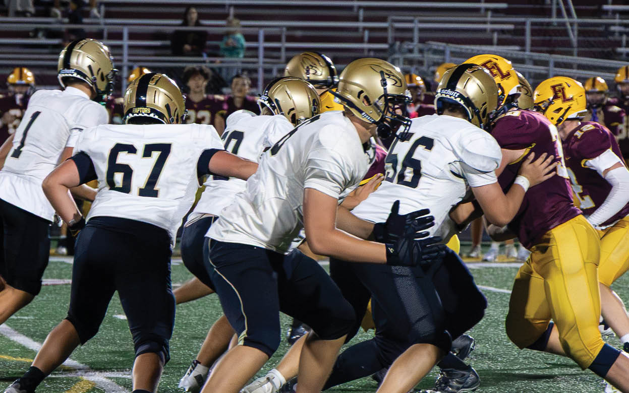 A group of football players wearing black and white uniforms. Description generated by AI