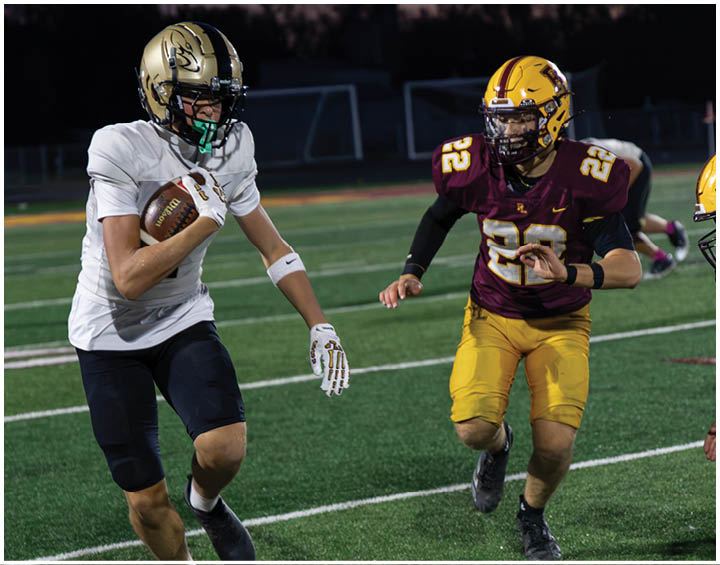 A group of football players wearing black and white uniforms. Description generated by AI