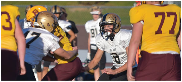 A football player is sliding on the ground. Description generated by AI
