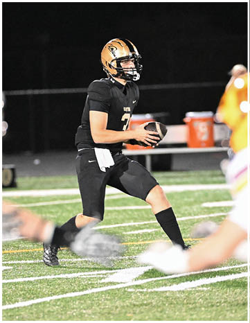 A football player running on the field. Description generated by AI