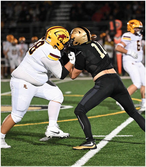 A group of football players wearing black and white uniforms. Description generated by AI