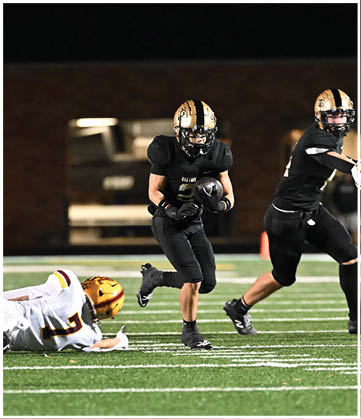 A football player running on the field. Description generated by AI