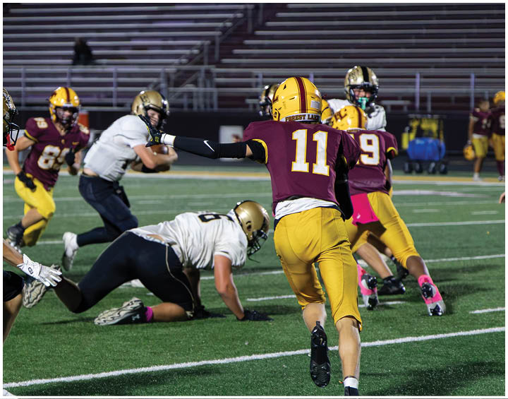 A group of football players wearing black and white uniforms. Description generated by AI