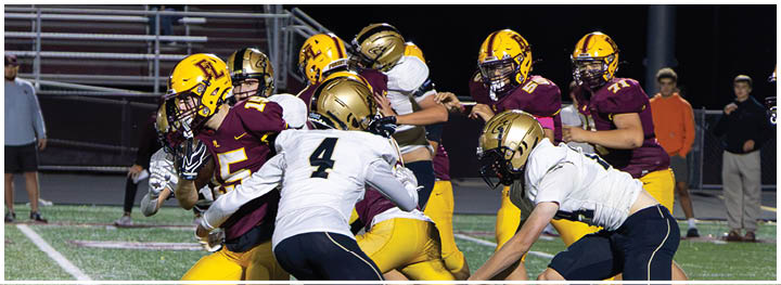 A football player is sliding on the ground. Description generated by AI