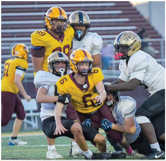 A group of football players wearing black and white uniforms. Description generated by AI