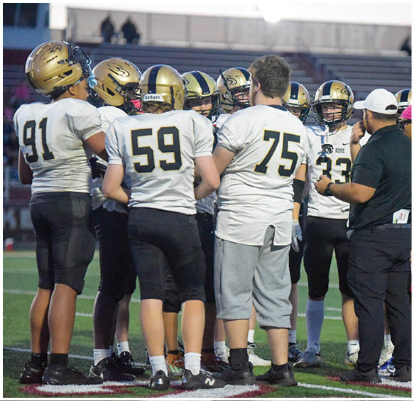 A group of football players wearing black and white uniforms. Description generated by AI