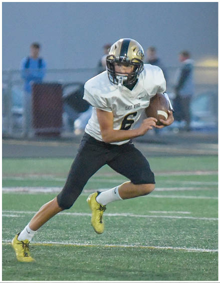 A football player running on the field. Description generated by AI