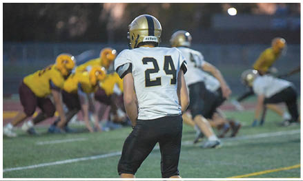 A football player running on the field. Description generated by AI
