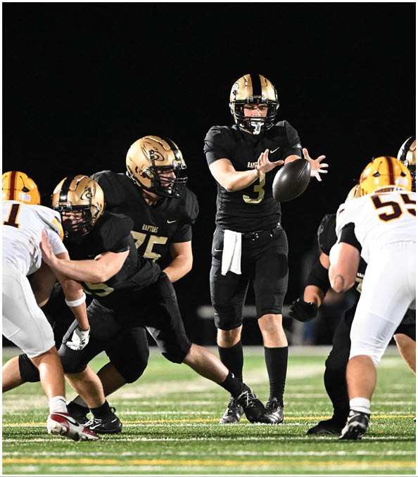 A group of football players wearing black and white uniforms. Description generated by AI