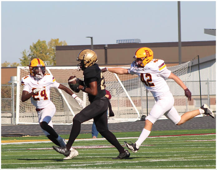A group of football players wearing black and white uniforms. Description generated by AI