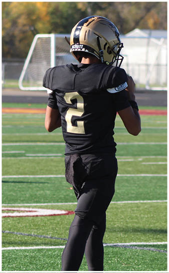 A football player running on the field. Description generated by AI