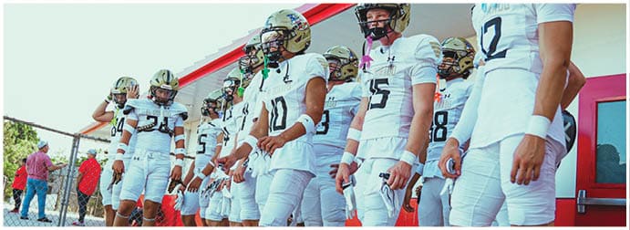 A group of football players on a field. Description generated by AI