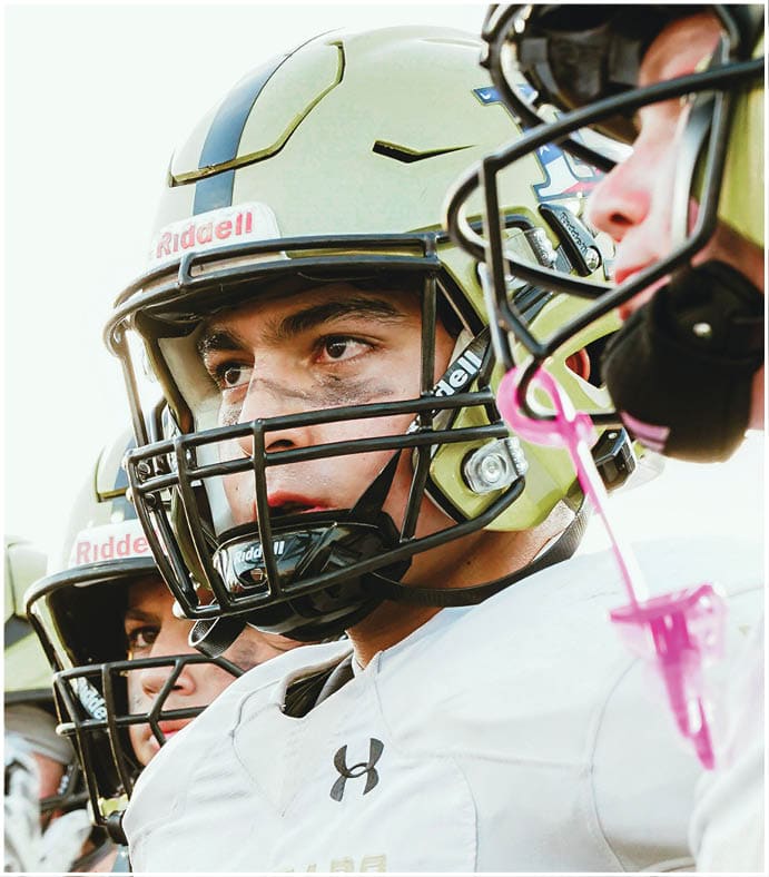 A group of football players on a field. Description generated by AI