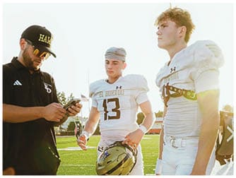 A group of football players on a field. Description generated by AI