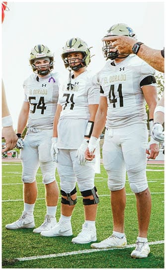 A group of football players on a field. Description generated by AI