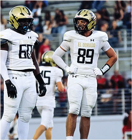 A group of football players celebrating a touchdown. Description generated by AI