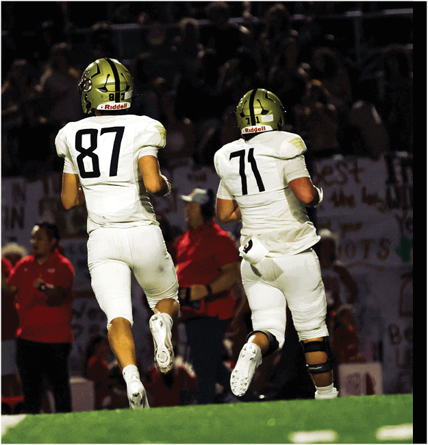 A group of football players celebrating a touchdown. Description generated by AI