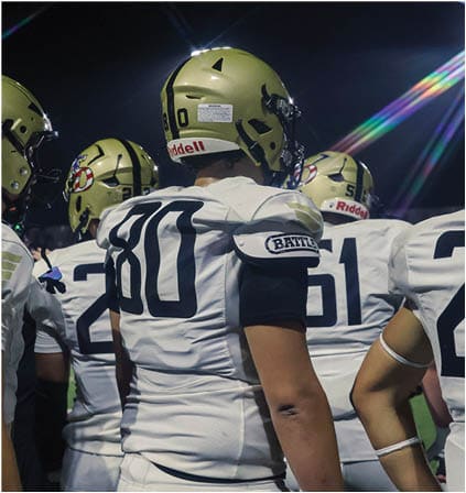 A group of football players celebrating a touchdown. Description generated by AI