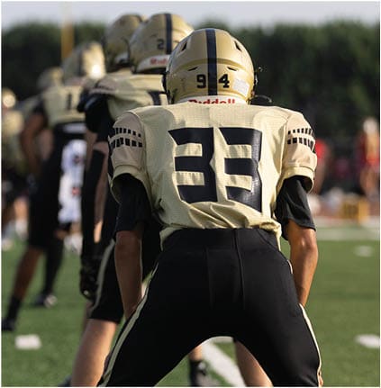 A group of football players celebrating a touchdown. Description generated by AI
