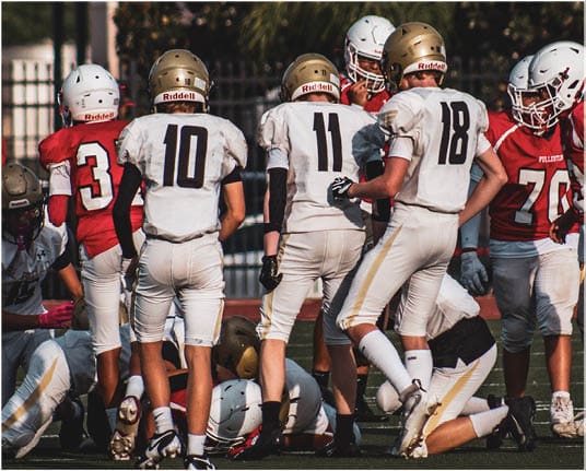 A group of football players celebrating a touchdown. Description generated by AI