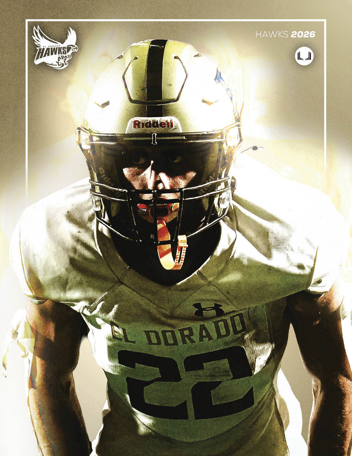 A person wearing a gold and white football uniform with the number 22 and a helmet is standing with a focused posture against a bright background. Description generated by AI