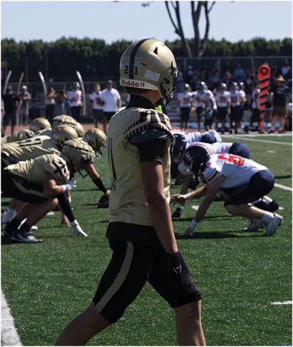 A group of football players on a field. Description generated by AI