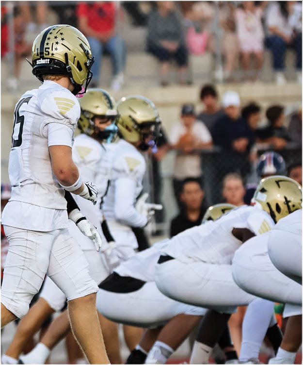 A group of football players on a field. Description generated by AI