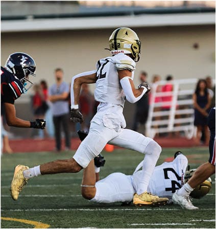 A group of football players celebrating a touchdown. Description generated by AI