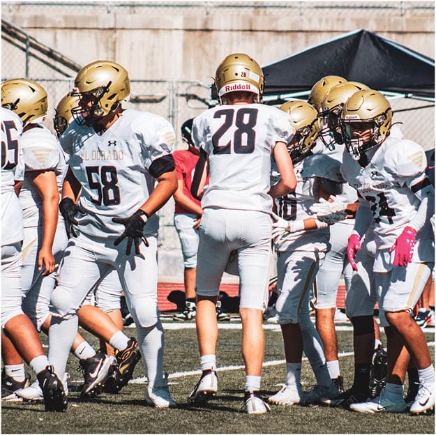 A group of football players celebrating a touchdown. Description generated by AI