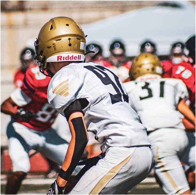 A group of football players celebrating a touchdown. Description generated by AI