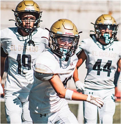 A group of football players celebrating a touchdown. Description generated by AI