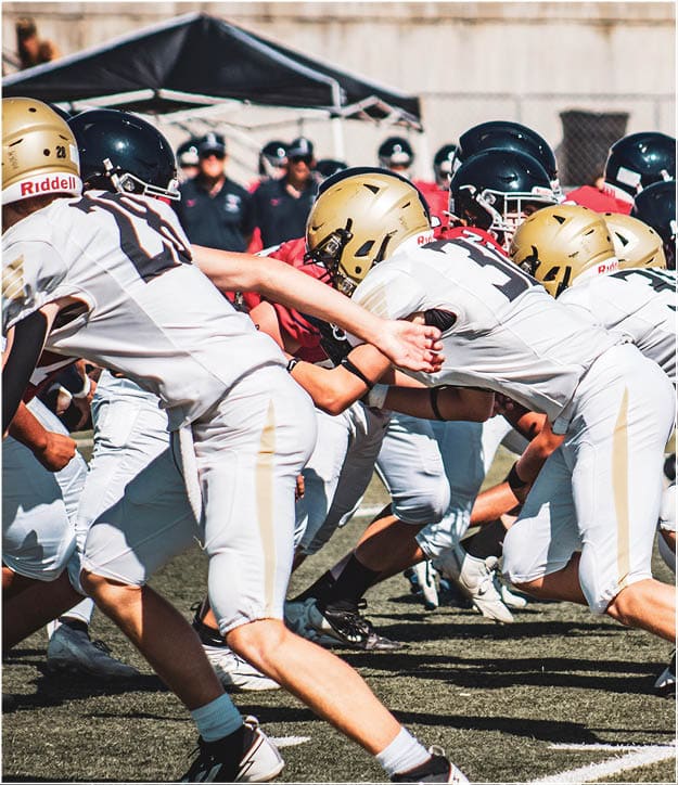 A group of football players on a field. Description generated by AI