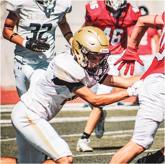 A group of football players celebrating a touchdown. Description generated by AI