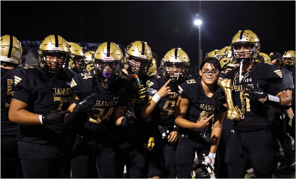 A group of football players celebrating a touchdown. Description generated by AI